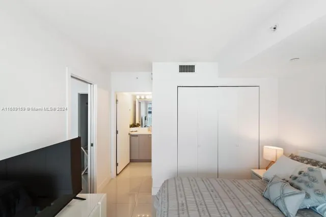 a bedroom with a bed and a view of bathroom