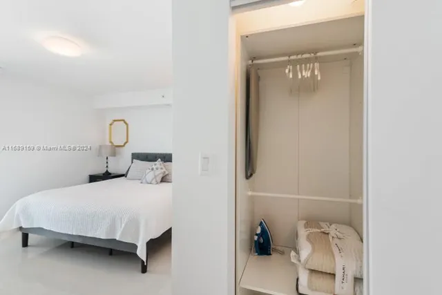 a bedroom with a bed and a table