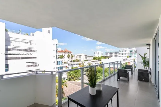 a dining room with furniture and a floor to ceiling window