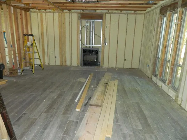 a very nice looking room with a large window and wooden floor