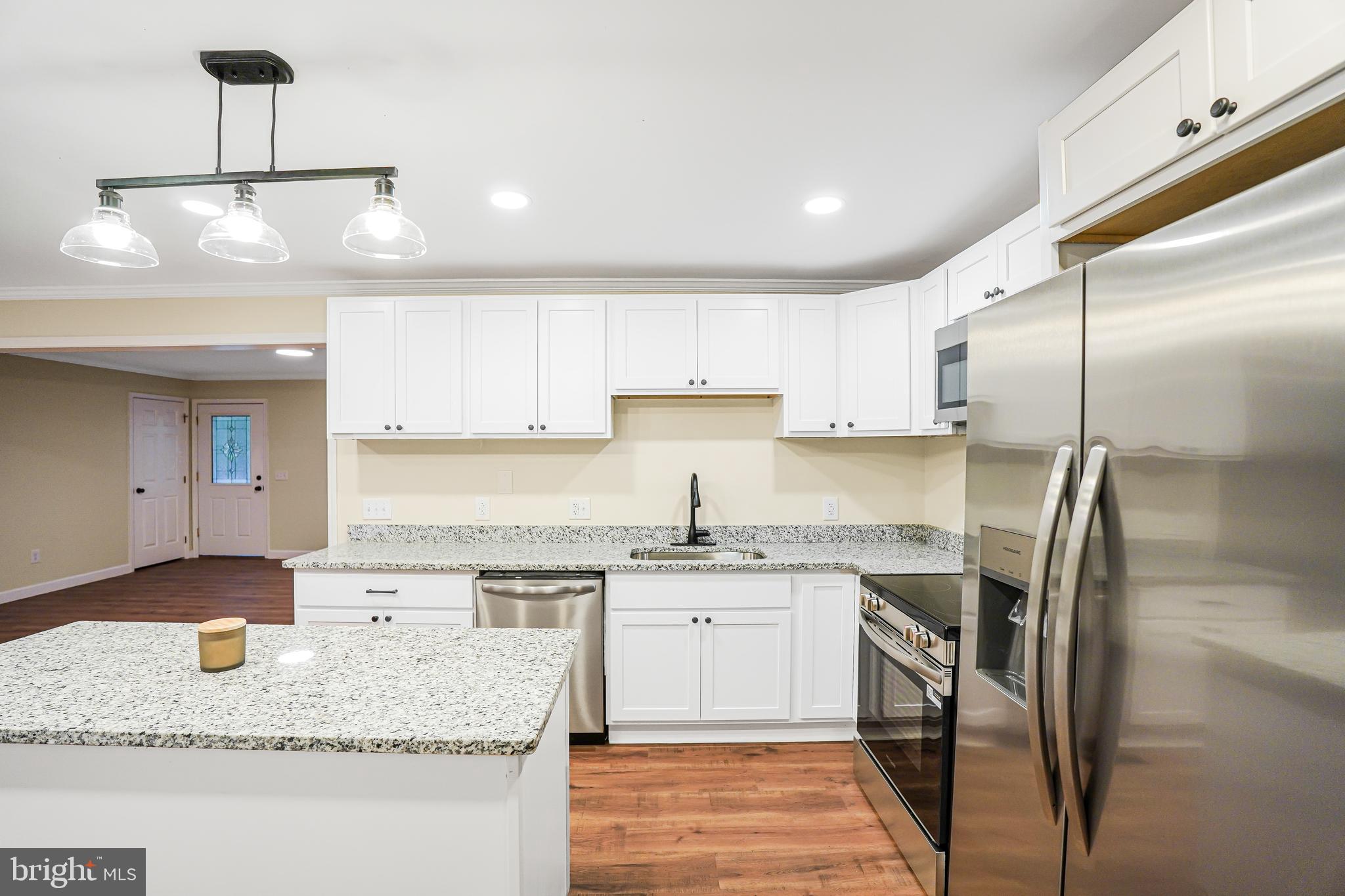 767 Loving Road Zion Crossroads, VA 22942 - Photo 8 of 33 a kitchen with stainless steel appliances granite countertop a sink a stove and a refrigerator