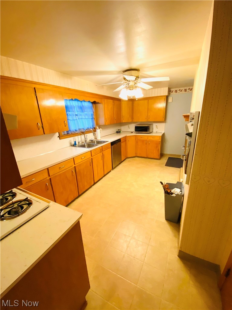 19119 West Middletown Road Beloit, OH 44609 - Photo 16 of 28 Kitchen featuring appliances with stainless steel finishes, light tile flooring, sink, and ceiling fan