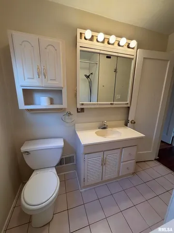 a bathroom with a sink toilet and mirror