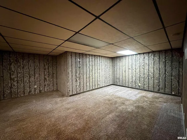 a view of a roof with wooden floor and city view