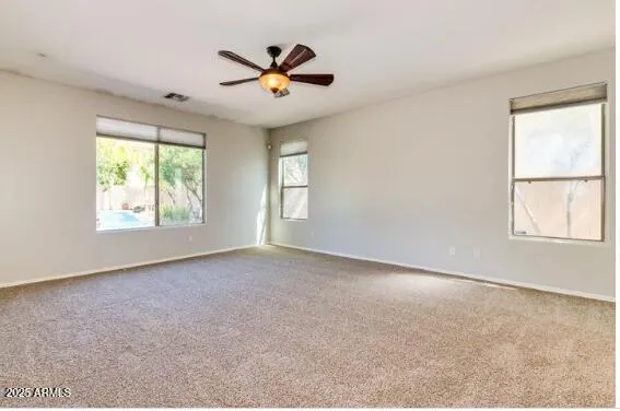 a view of a livingroom with a ceiling fan and window