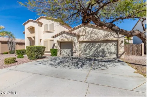 a view of a white house next to a road and a yard