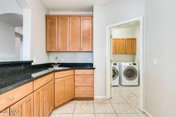 a view of a storage and utility room with washer and dryer