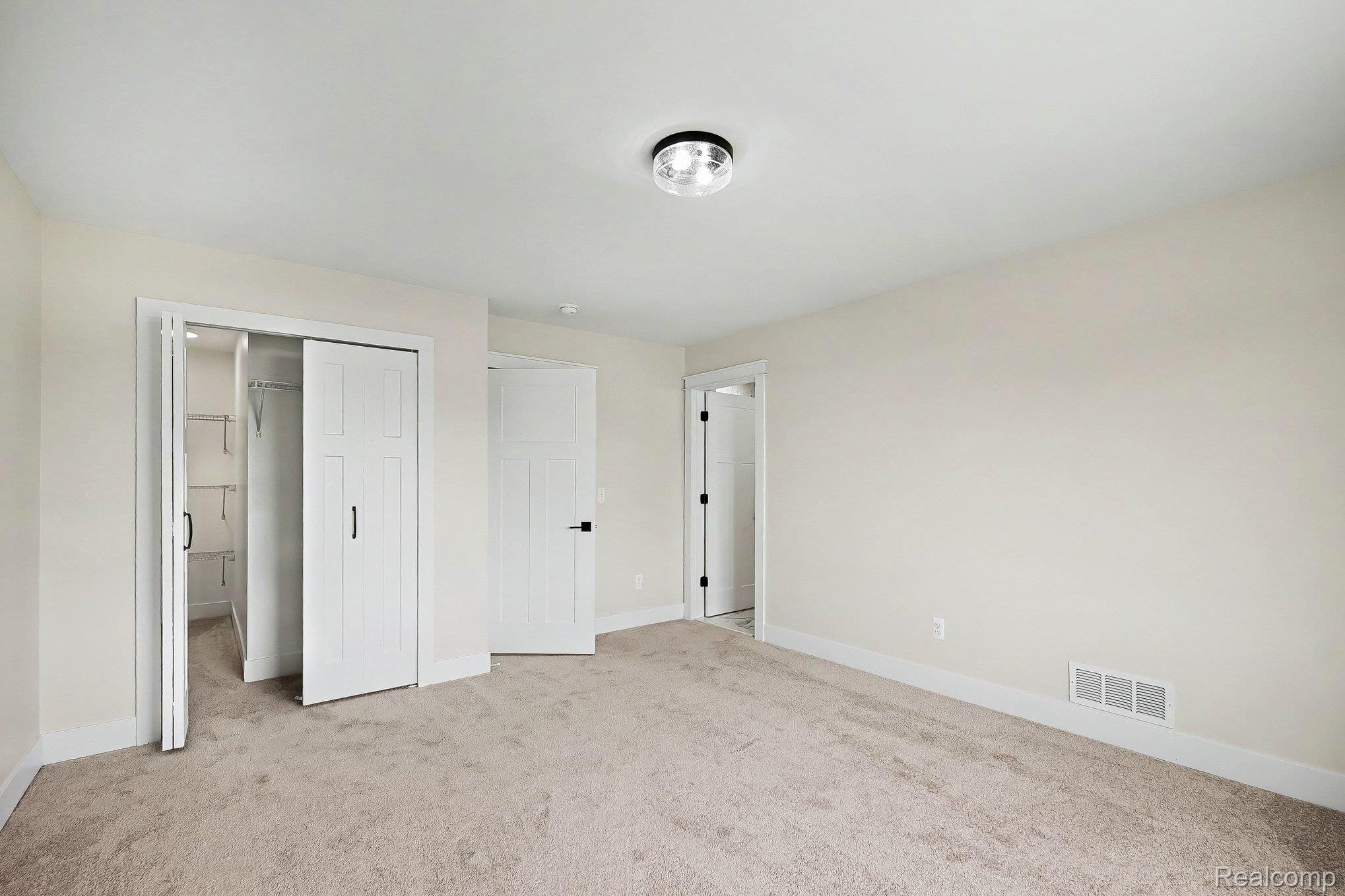 57560 Omo Road Ray, MI 48096 - Photo 31 of 44 Upper level bedroom 4. Neutral wall tones complement plush carpeting, creating a versatile interior