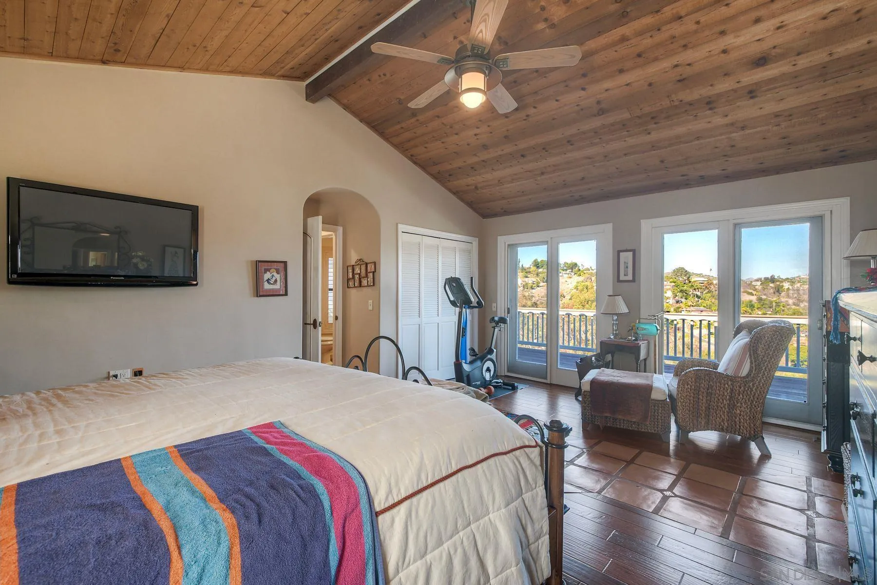 2848 Sunset Hills Escondido, CA 92025 - Photo 34 of 67 a bedroom with a bed a flat screen tv and couches chairs