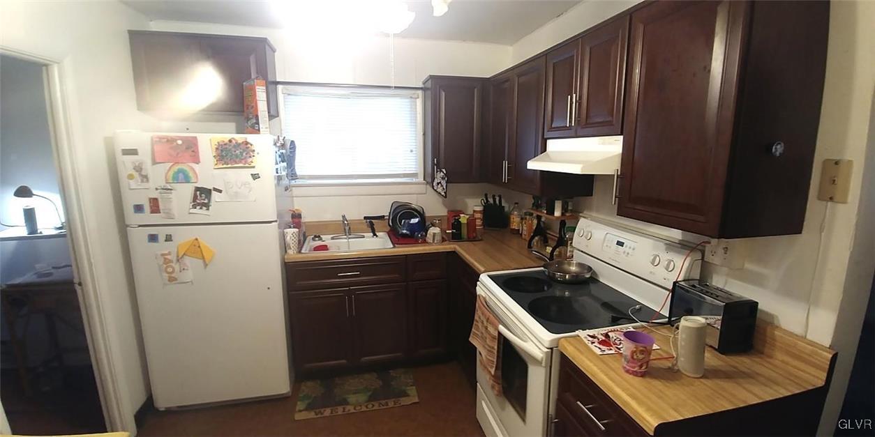 709 East Union Boulevard Bethlehem, PA 18018 - Photo 6 of 10 a kitchen with a sink a refrigerator and cabinets
