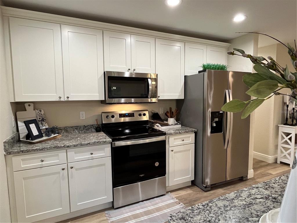 274 Southeast 34th Place Ocala, FL 34471 - Photo 20 of 97 a kitchen with stainless steel appliances granite countertop a refrigerator a stove a sink and a microwave