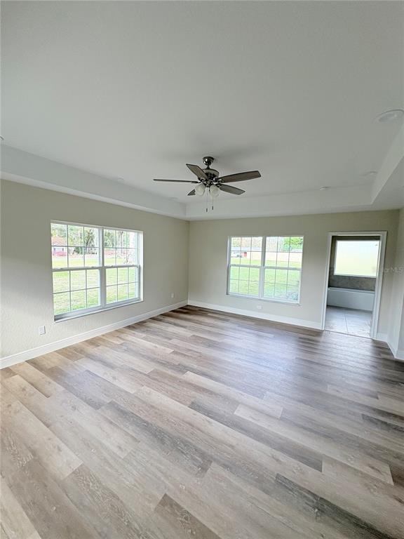 274 Southeast 34th Place Ocala, FL 34471 - Photo 43 of 89 an empty room with wooden floor and windows