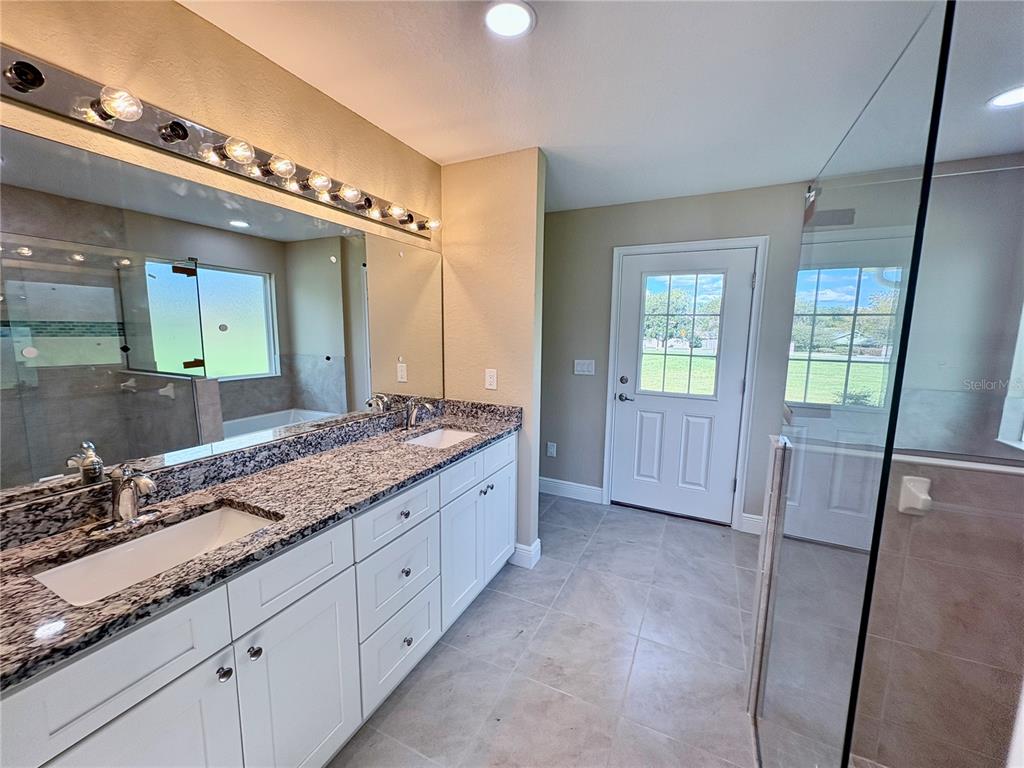 274 Southeast 34th Place Ocala, FL 34471 - Photo 45 of 97 a bathroom with a granite countertop sink and a mirror