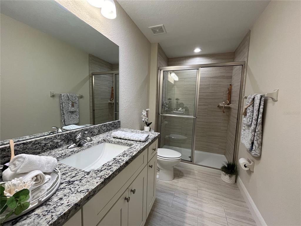 274 Southeast 34th Place Ocala, FL 34471 - Photo 56 of 89 a bathroom with a granite countertop sink toilet and shower