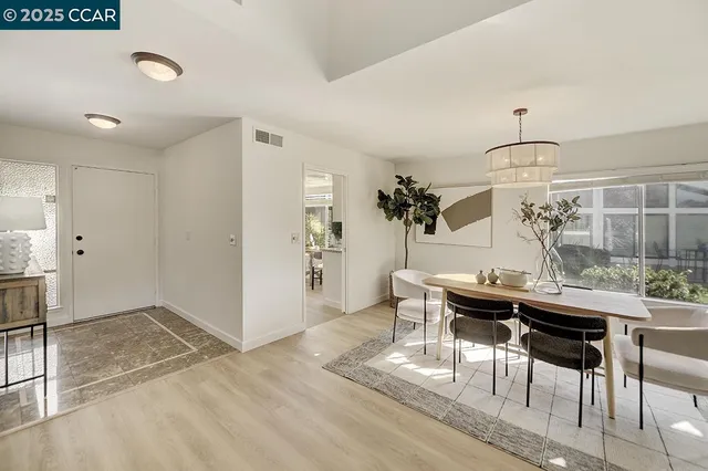 a view of a dining room with furniture wooden floor and chandelier