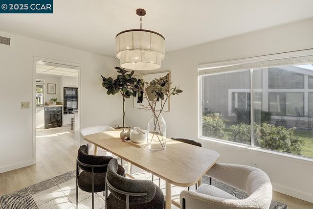 a kitchen with a sink and chairs