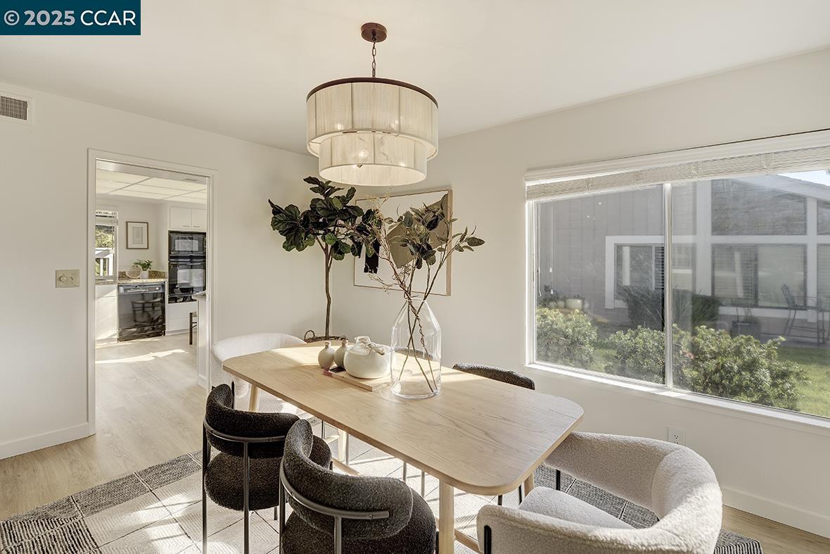975 Terra California Drive, Unit 1 Walnut Creek, CA 94595 - Photo 14 of 58 a view of a dining room with furniture wooden floor and chandelier