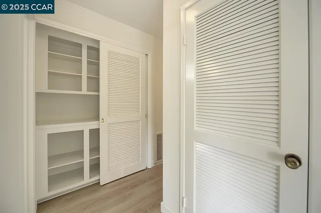 a bedroom with bed and a large window with outer view