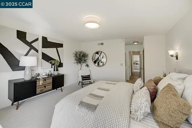 a bedroom with a bed and mirror