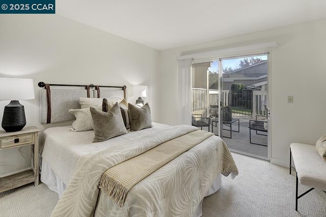 a front view of a house with a garden and tree