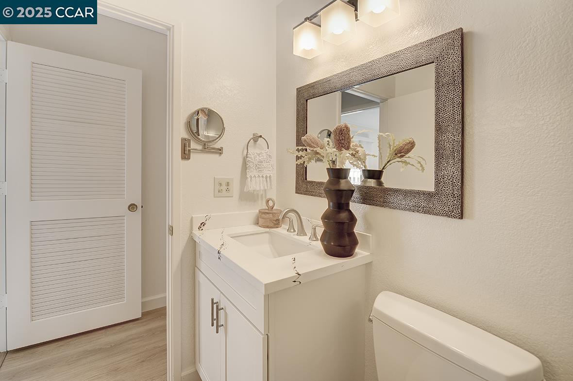 975 Terra California Drive, Unit 1 Walnut Creek, CA 94595 - Photo 45 of 58 a bathroom with a toilet sink and mirror