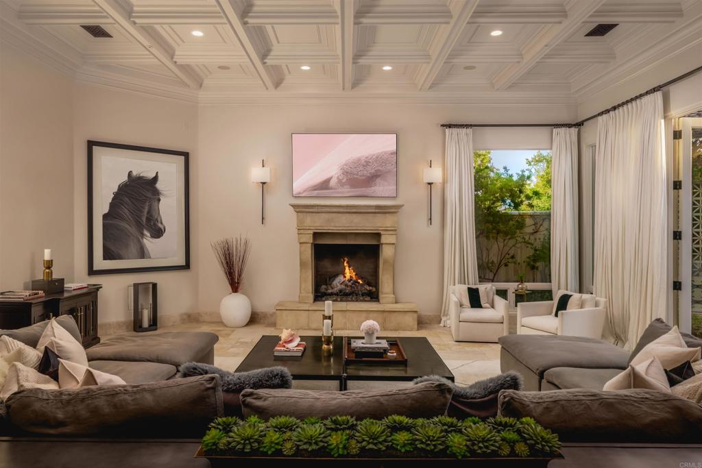 6853 Rancho Valencia Road Rancho Santa Fe, CA 92067 - Photo 7 of 29 a living room with furniture and a fireplace