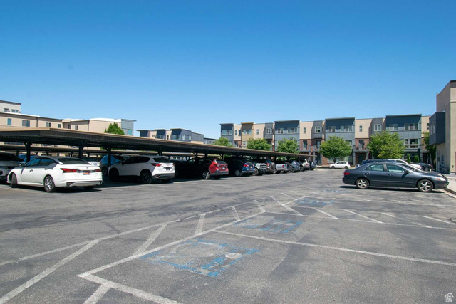 4276 South Main Street, Unit 303 Murray, UT 84107 - Photo 20 of 20 Covered parking structures extending across the property, providing sheltered vehicle accommodation