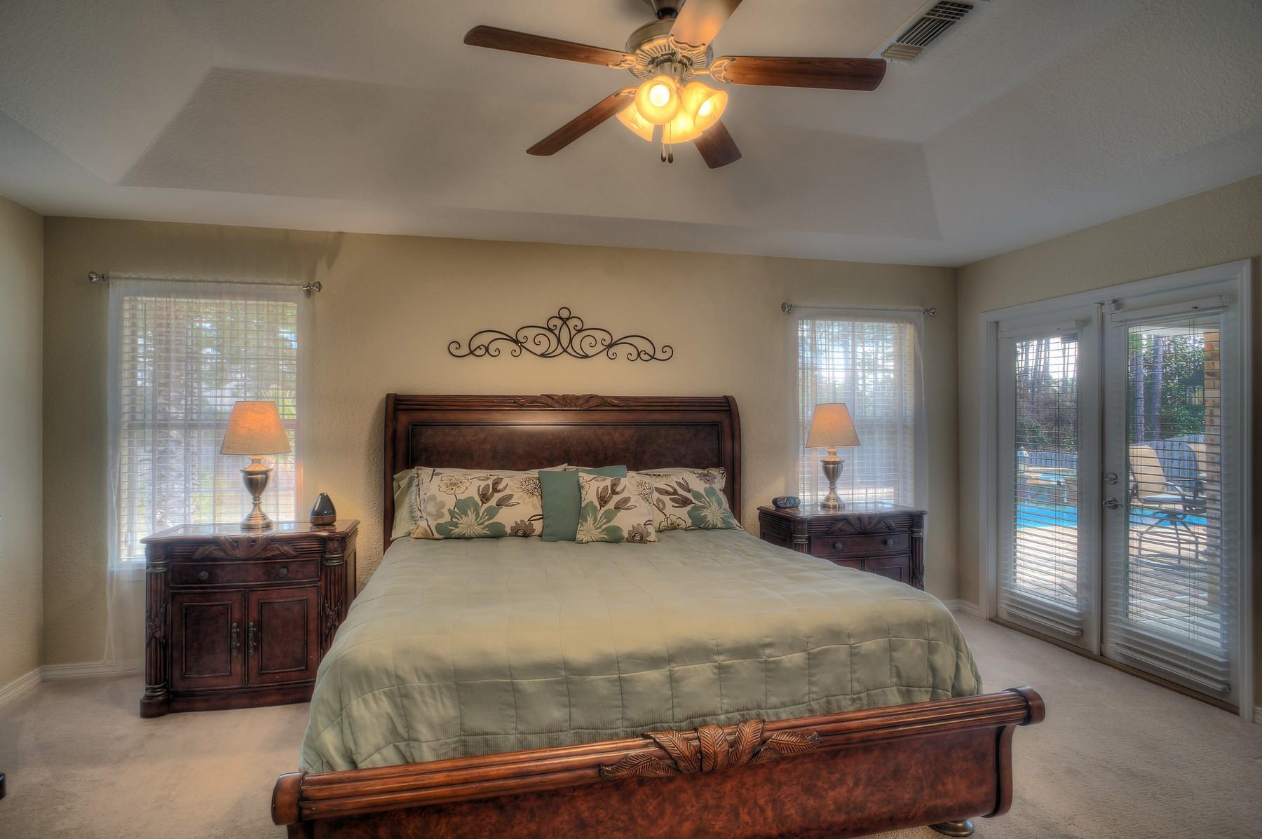 588 East Shipwreck Road Santa Rosa Beach, FL 32459 - Photo 14 of 29 a bedroom with a bed and a chandelier
