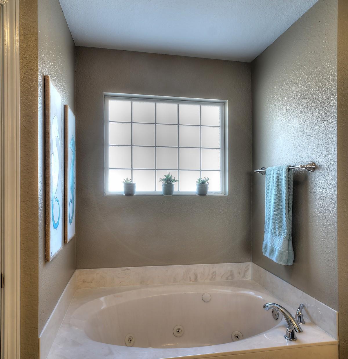 588 East Shipwreck Road Santa Rosa Beach, FL 32459 - Photo 17 of 29 a bath tub sitting in a bathroom next to a window