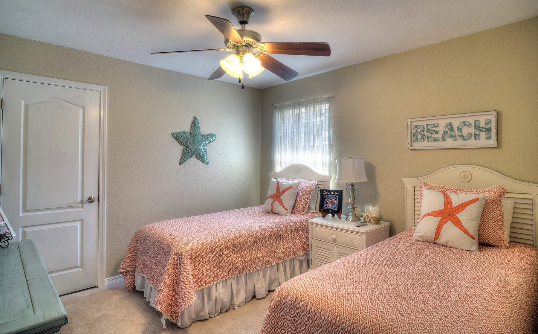 588 East Shipwreck Road Santa Rosa Beach, FL 32459 - Photo 19 of 29 a bedroom with two beds and a chandelier