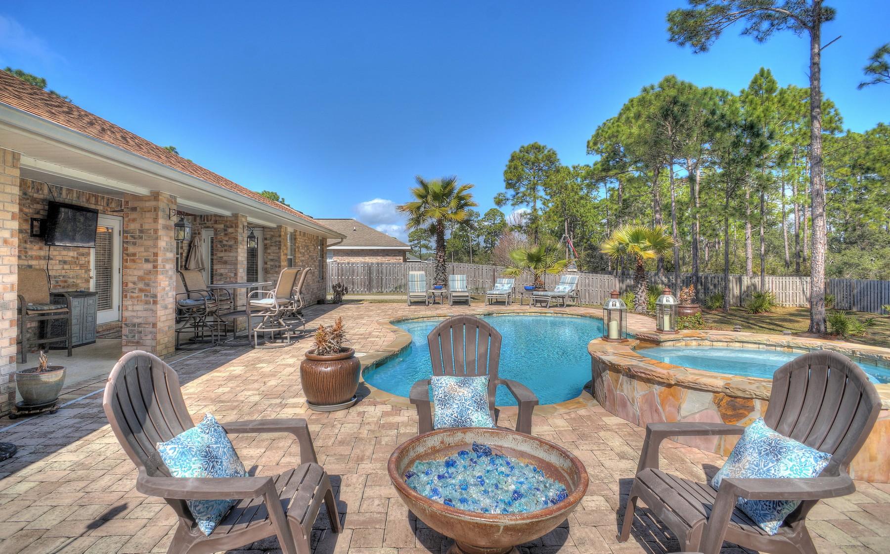 588 East Shipwreck Road Santa Rosa Beach, FL 32459 - Photo 5 of 29 a view of a patio with dining table and chairs and potted plants