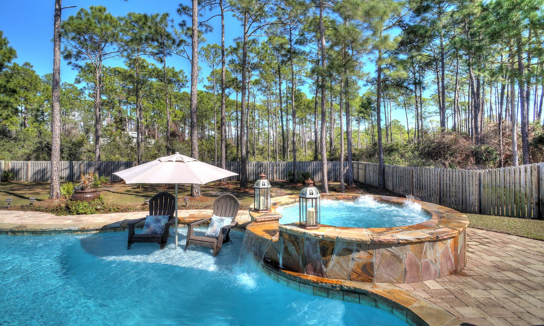 588 East Shipwreck Road Santa Rosa Beach, FL 32459 - Photo 7 of 29 a view of a patio with chairs and a small yard