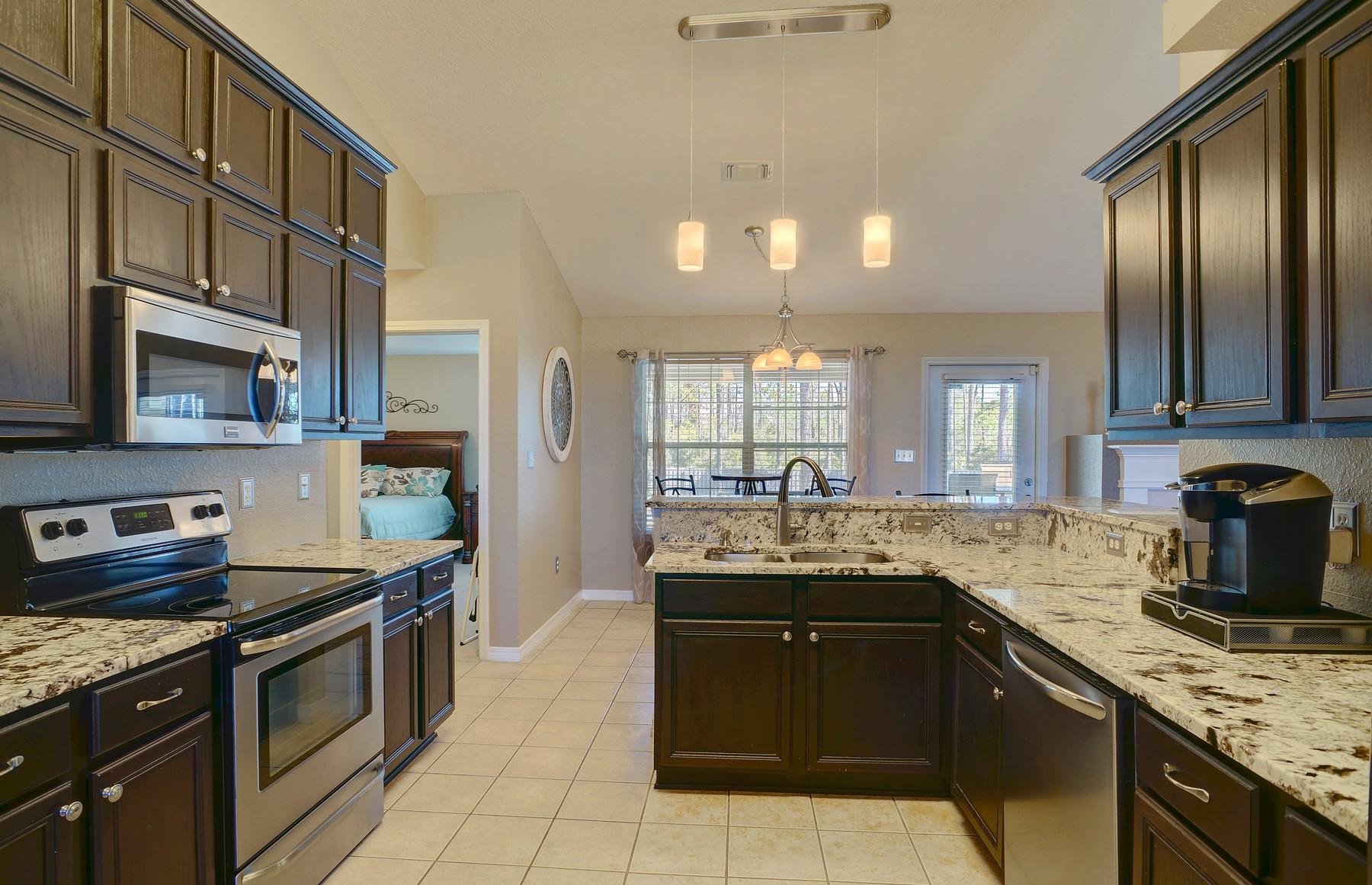 588 East Shipwreck Road Santa Rosa Beach, FL 32459 - Photo 9 of 29 a kitchen with stainless steel appliances granite countertop a sink stove and refrigerator