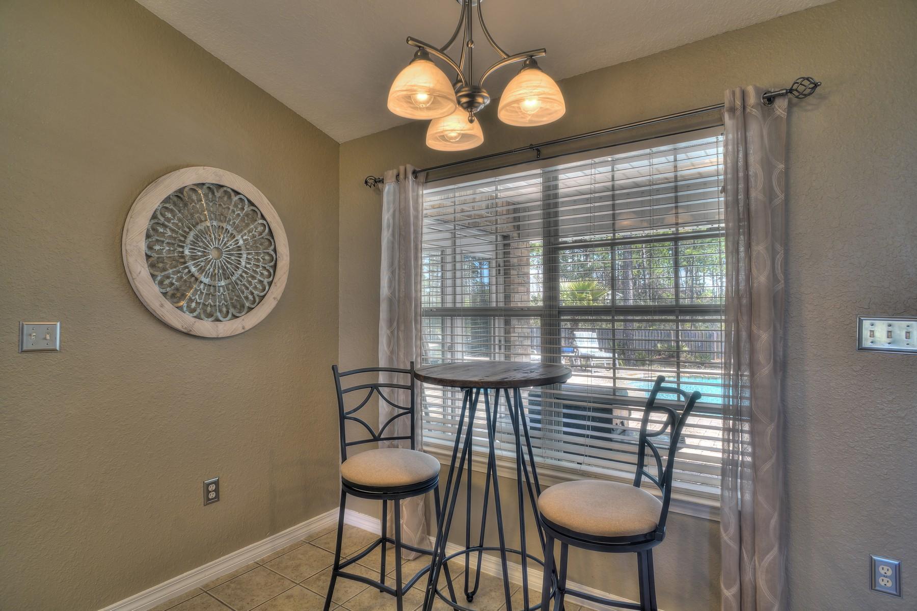 588 East Shipwreck Road Santa Rosa Beach, FL 32459 - Photo 10 of 29 a view of a room with furniture wooden floor and a chandelier