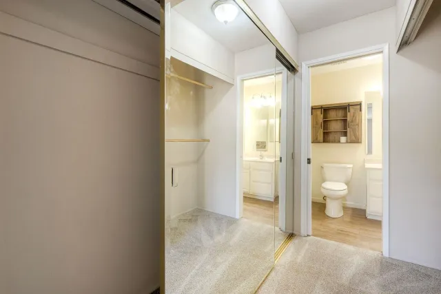 view of a bathroom with a toilet and a shower