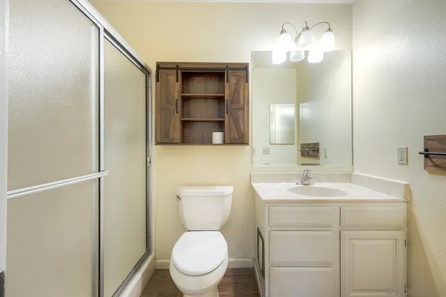 a bathroom with a toilet a sink and a mirror