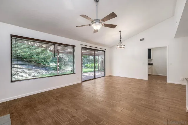 a view of a livingroom with a ceiling fan and window
