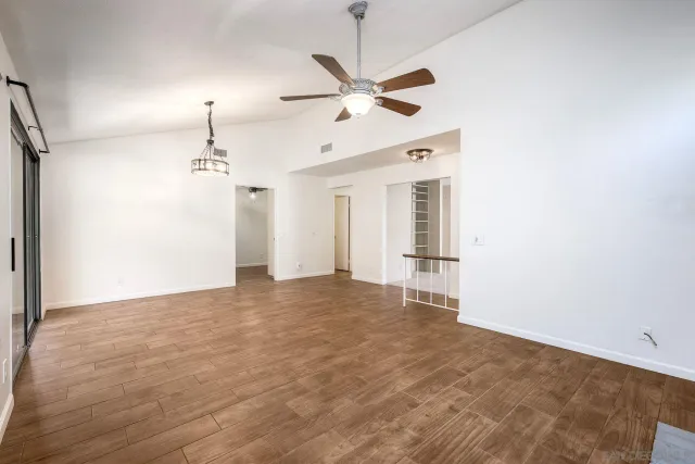 a view of an empty room with a ceiling fan