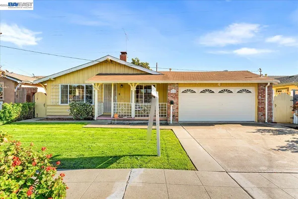 a front view of a house with yard and furniture