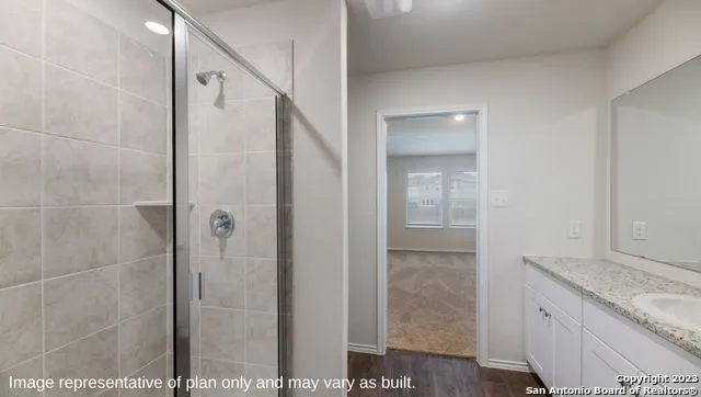 a bathroom with a granite countertop shower mirror and a sink