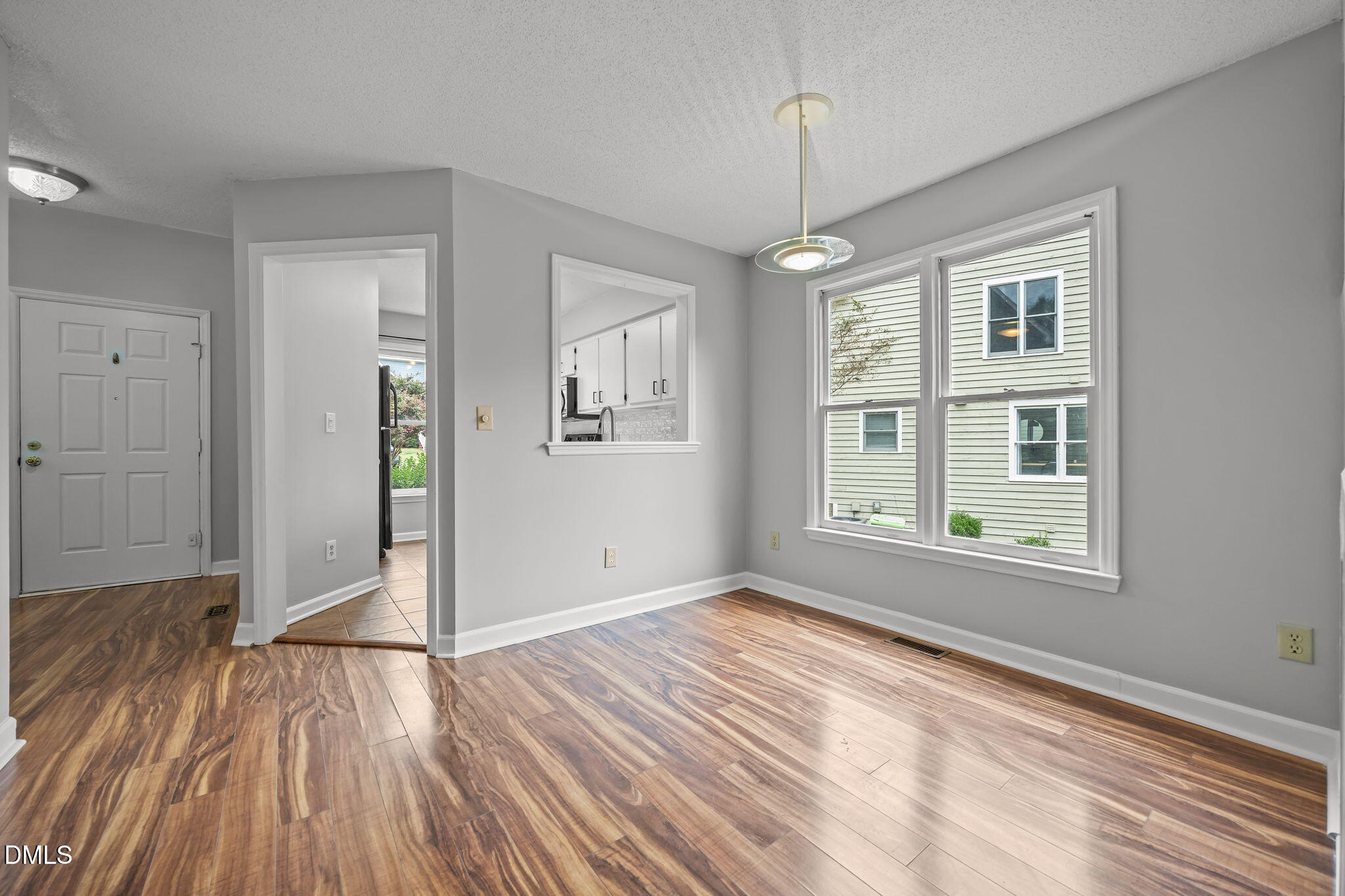 1626 Oakland Hills Way Raleigh, NC 27604 - Photo 3 of 23 an empty room with wooden floor cabinet and windows