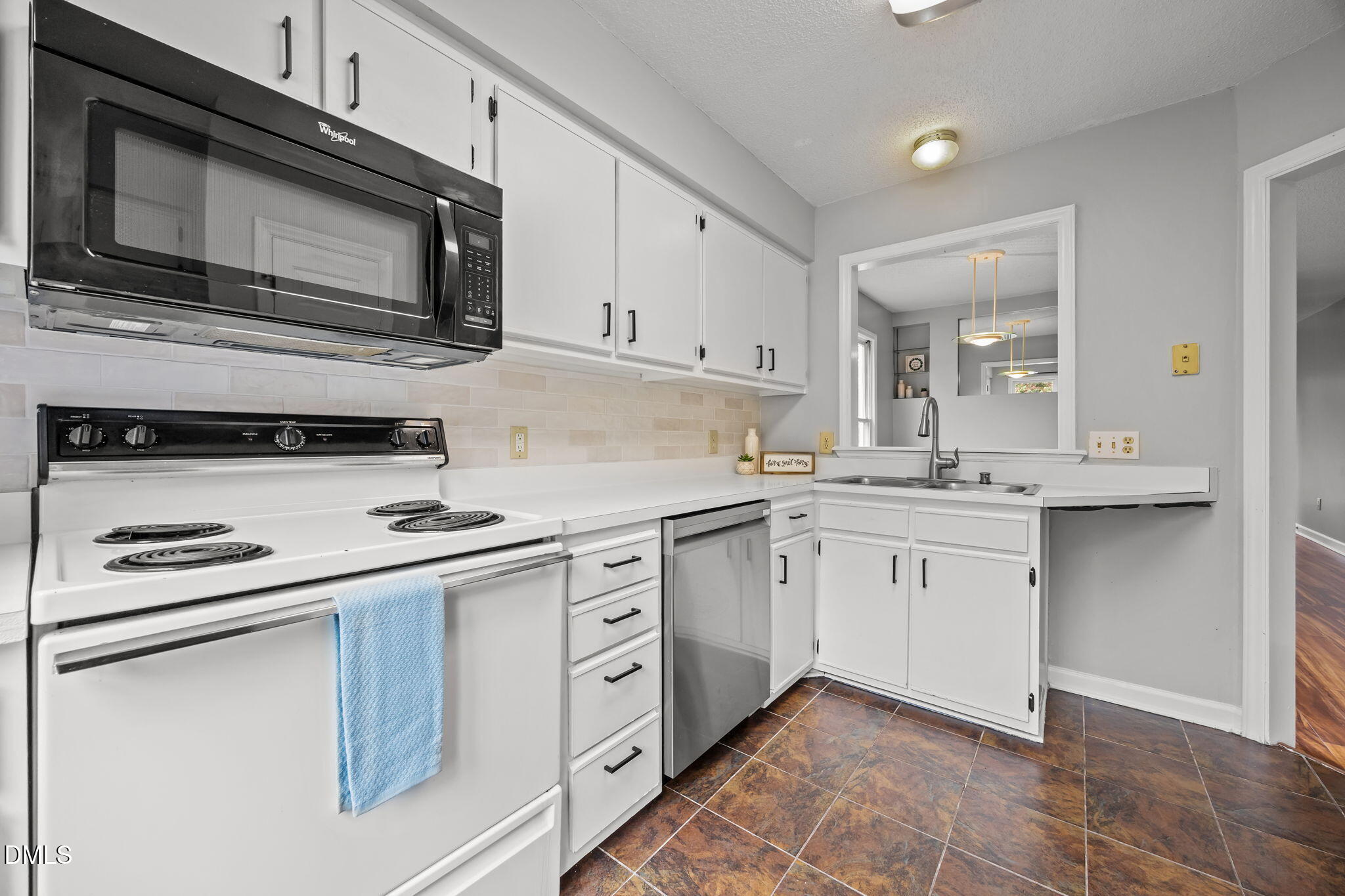 1626 Oakland Hills Way Raleigh, NC 27604 - Photo 7 of 23 a kitchen with stainless steel appliances granite countertop a sink stove and microwave