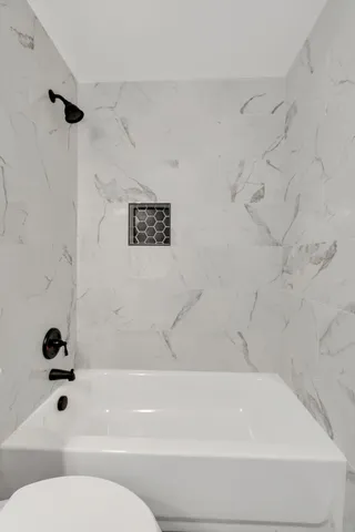 a bathroom with a shower and a toilet