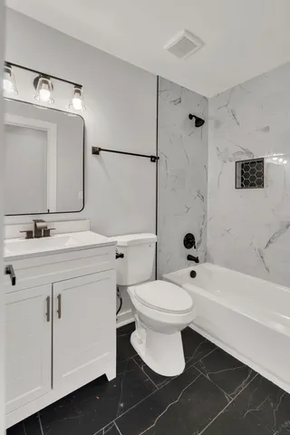 a bathroom with a sink toilet a mirror and shower
