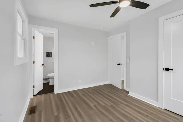 a view of empty room with wooden floor