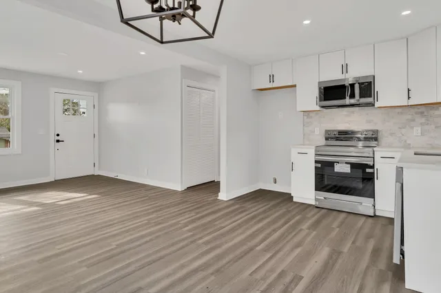a view of kitchen with microwave and cabinets