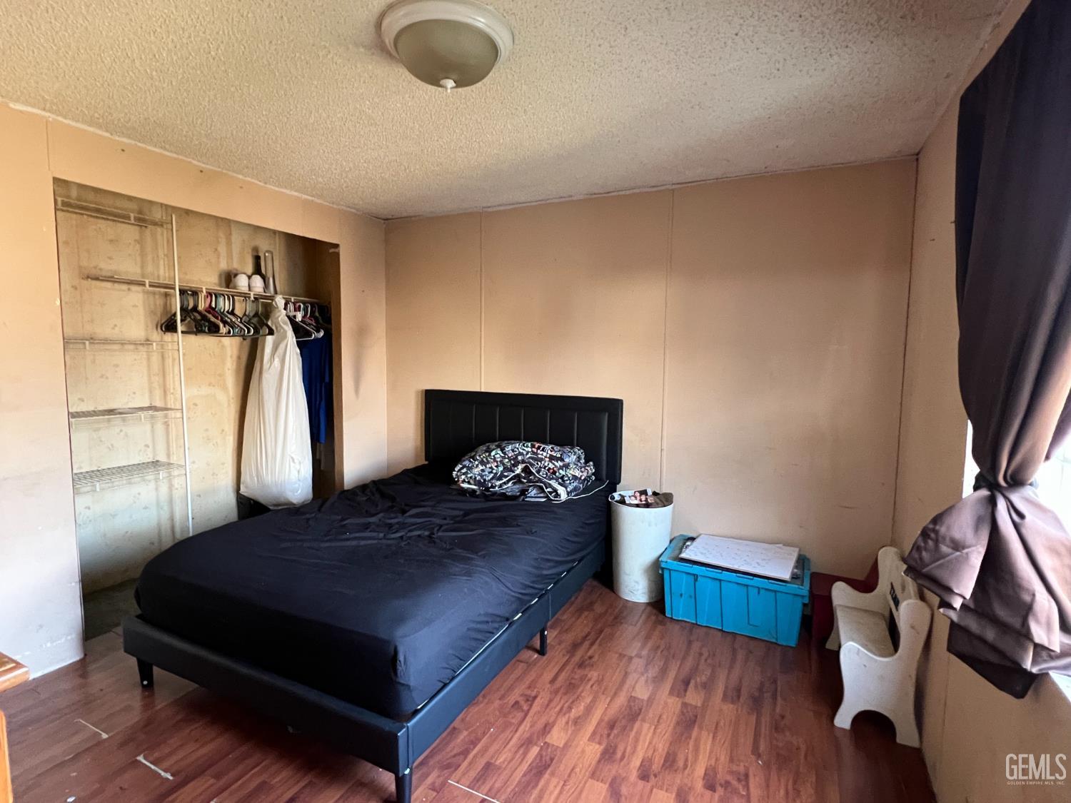 Undisclosed Address Bakersfield, CA 93309 - Photo 6 of 14 a bedroom with a bed and wooden floor