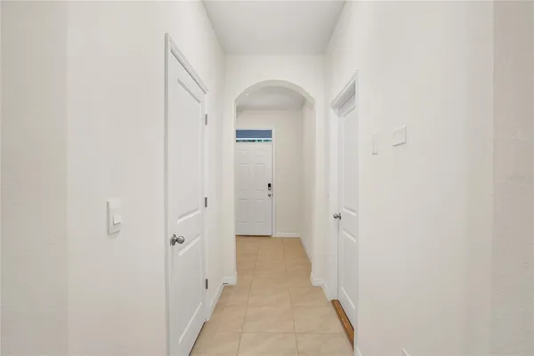 a large white room with a large window and front door