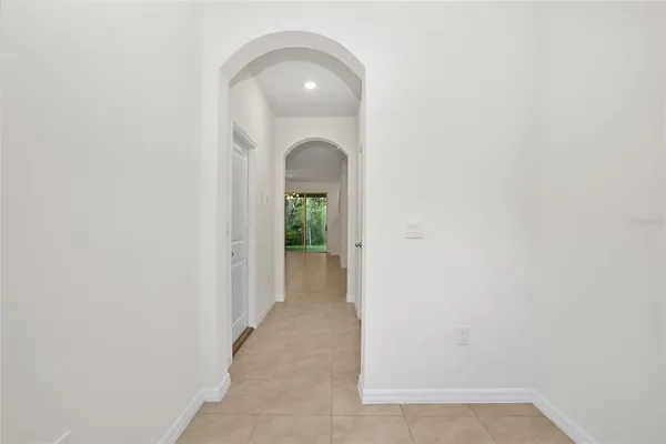 an empty room with a fireplace and a refrigerator