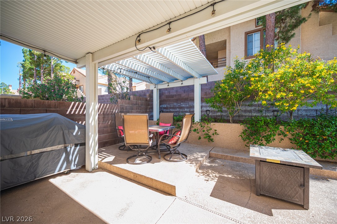 718 Rusty Spur Drive Henderson, NV 89014 - Photo 21 of 50 A private outdoor space with a comfortable dining area offers a serene setting for relaxation.